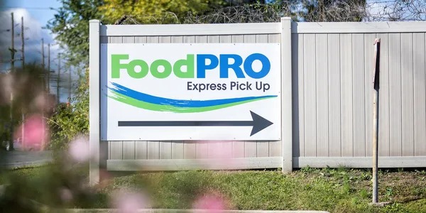 FoodPRO Express Pick Up sign offers quick and fresh food service in a vibrant setting.